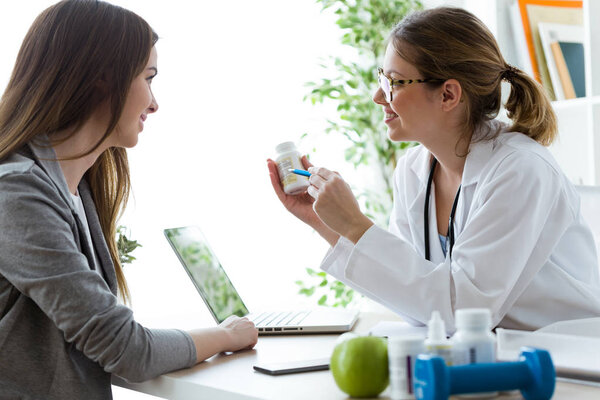 Female dietician prescribing nutritional supplement for patient in the consultation.