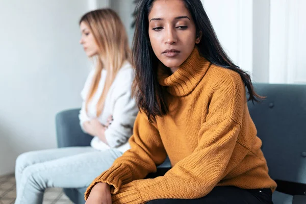 Zwei aufgebrachte Freunde, die nach einem Streit auf dem heimischen Sofa nicht miteinander reden. — Stockfoto