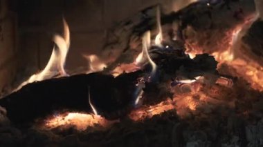 Close-up of warm cozy burning fire in a brick fireplace. 