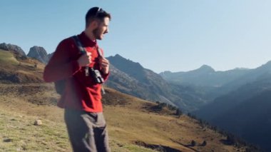 Video of man travel hiker enjoying the nature while looking the landscape with binoculars in the mountain.
