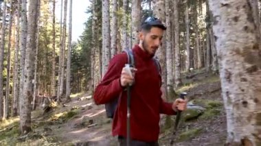 Video of hiker young man traveler with backpack doing trekking in the natural forest.