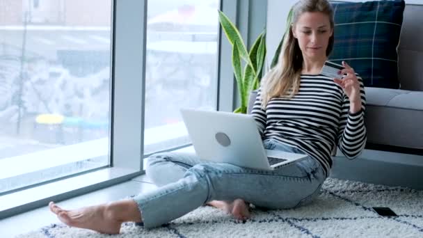 Video Pretty Young Woman Using Her Laptop While Sitting Floor — Stockvideo