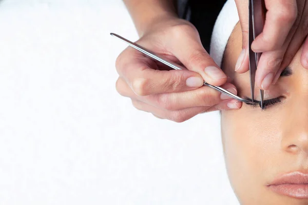 Shot Cosmetologist Doing Eyelash Extension Procedure Woman White Background — Stock fotografie
