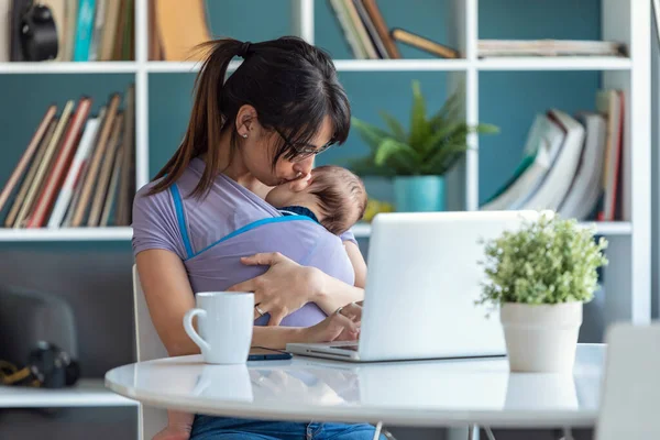 Shot Pretty Young Mother Kissing Her Baby Sling While Working — Stock Photo, Image