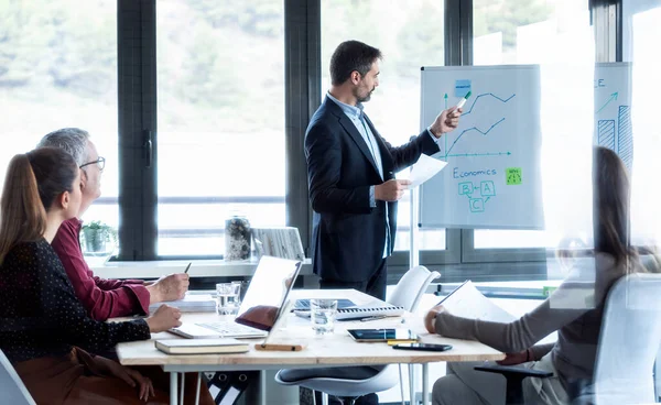 Shot Handsome Businessman Pointing White Blackboard Explain Project Her Colleagues — Stock Photo, Image