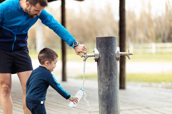 Shot Funny Little Boy Filling His Water Bottle Public Fountain — Stock Photo, Image