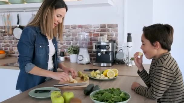 Video Hermosa Madre Preparando Plato Frutas Mientras Hijo Come Pedazo — Vídeos de Stock