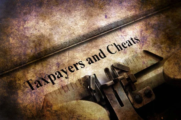 Taxpayers and cheats text on vintage typewriter — Stock Photo, Image