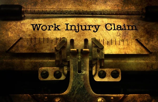 Work injury claim on typewriter — Stock Photo, Image