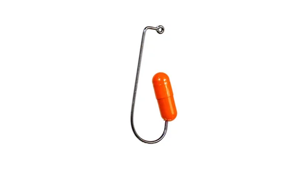 Píldora naranja en un gancho de pesca aislado sobre fondo blanco — Foto de Stock