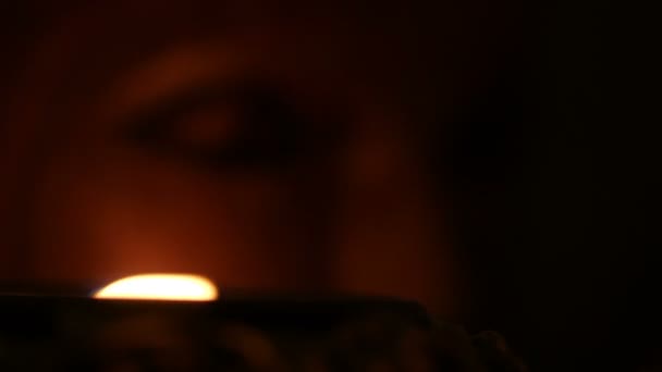 Close up of totem face lit by candle — Stock Video