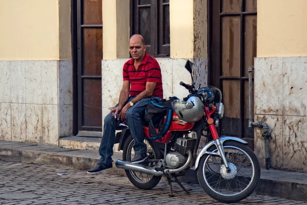 Kubański człowiek siedzi na motocyklu — Zdjęcie stockowe