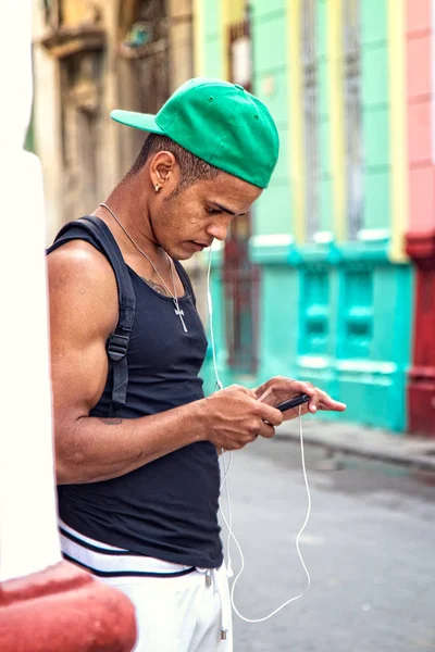 Cuban Youth Using Mobile Device Royalty Free Stock Images