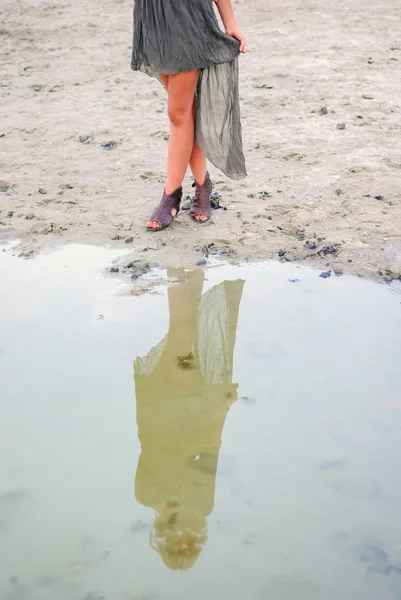 Woman walking barefoot through puddle outdoors — Stock Photo, Image