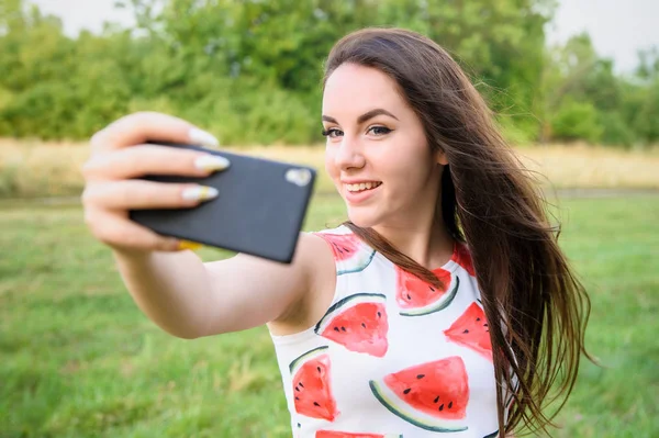 Młoda piękna dziewczyna robi selfie o zachodzie słońca — Zdjęcie stockowe