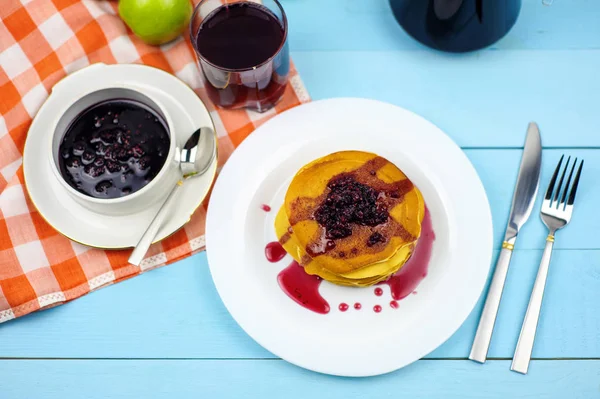 Pancake dengan selai raspberry dan jus anggur dengan latar belakang biru — Stok Foto