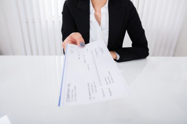 Businesswoman Offering Cheque clipart