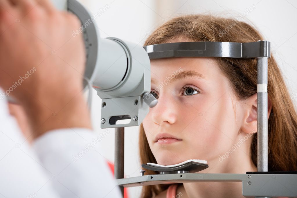 An Optometrist Doing Vision Testing Of Girl