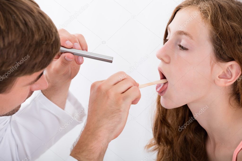 Close-up Of Doctor Examining Girl's Throat