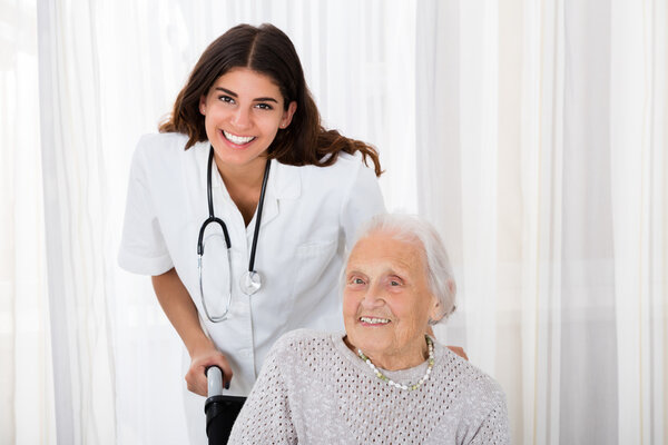 Female Doctor With Handicapped Senior Patient