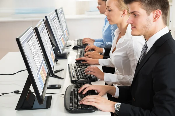 Businesspeople Typing On Desktop Computers — Stock Photo, Image