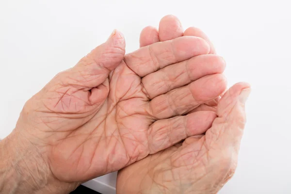 Senior Woman Hands On Desk Stock Photo