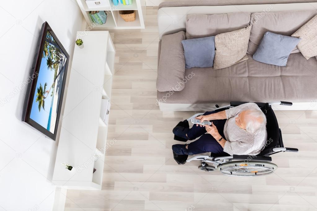 Elder Woman Watching Movie On Television