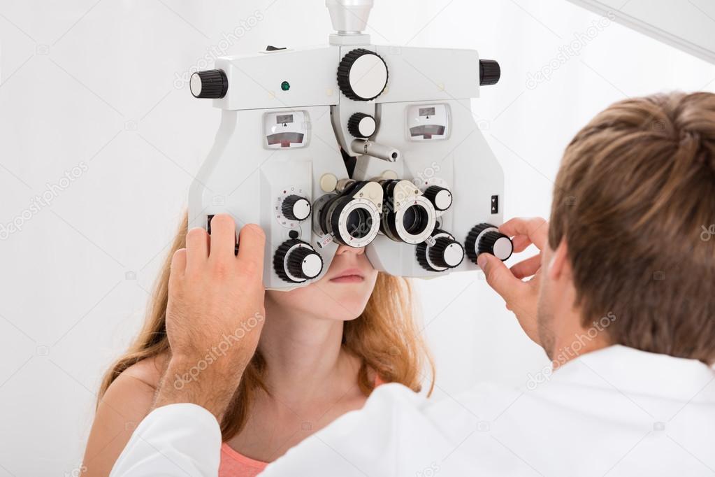 Optometrist Doing Sight Testing For Girl