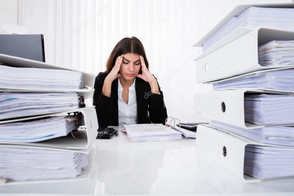 Depressed Businesswoman Checking Invoice