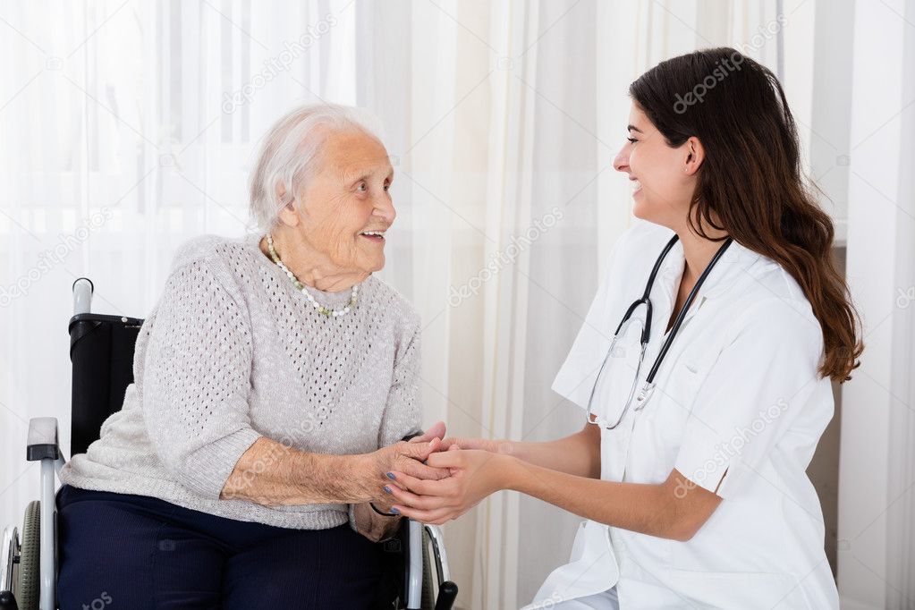 Doctor Consoling Handicapped Senior Patient