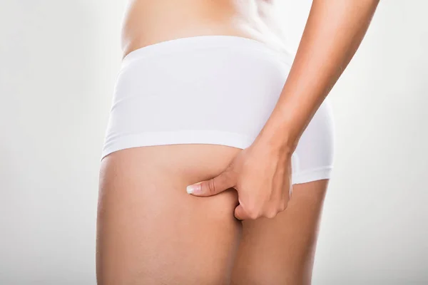 Woman Pinching Excessive Fat Of Buttock — Stock Photo, Image