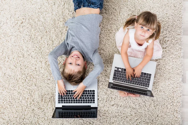 Dos niños con computadoras portátiles — Foto de Stock