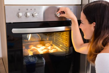 Woman Using Microwave Oven clipart