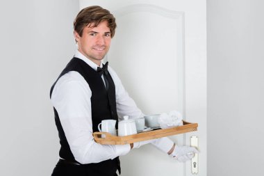 Waiter Carrying Coffee Set clipart