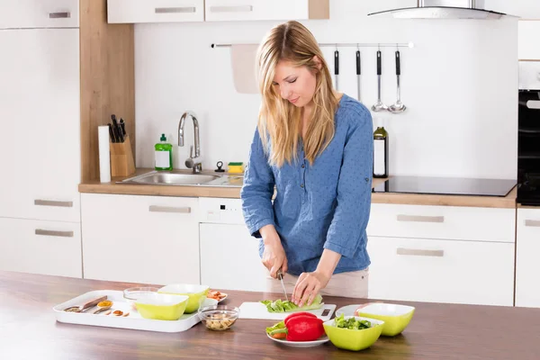 Frau schneidet Gemüse — Stockfoto