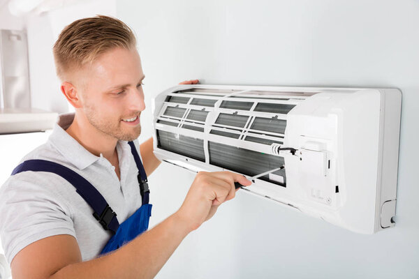 Technician Repairing Air Conditioner