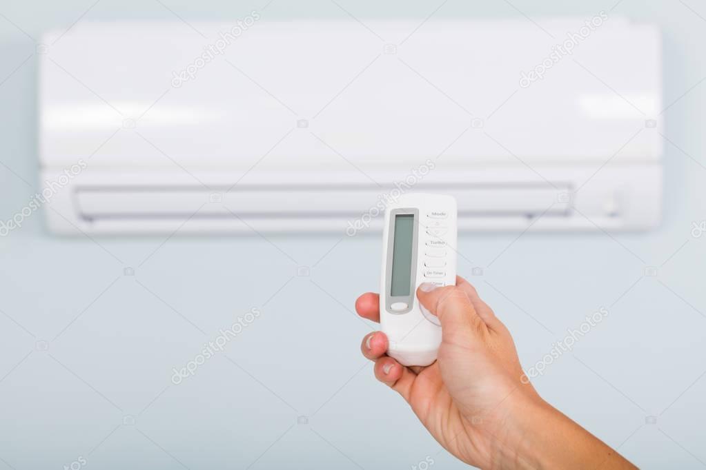 Person Operating Air Conditioner