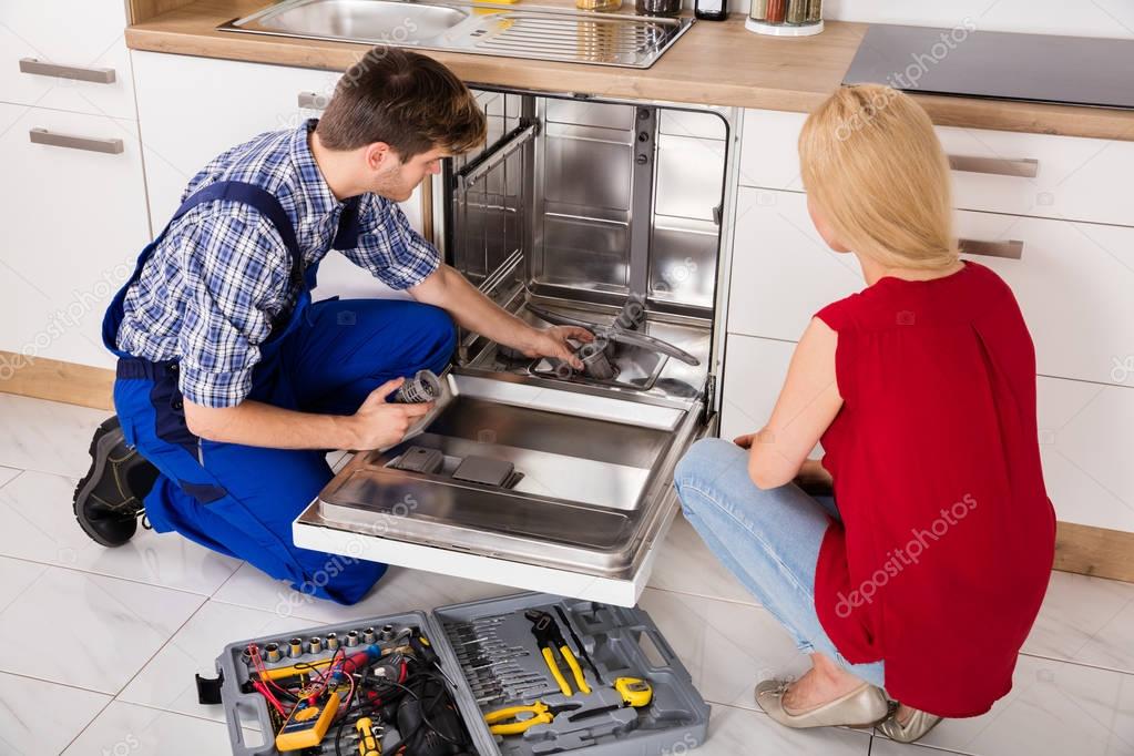 Repairman Repairing Dishwasher