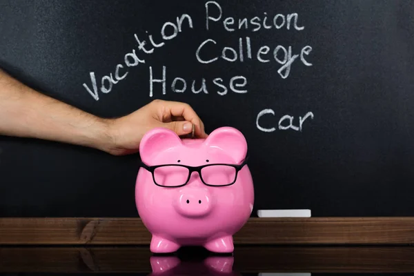 Person Inserting Coin In Piggybank — Stock Photo, Image