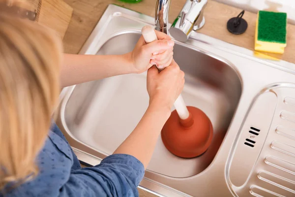 Woman Using Plunger In Sink — Stock Photo, Image