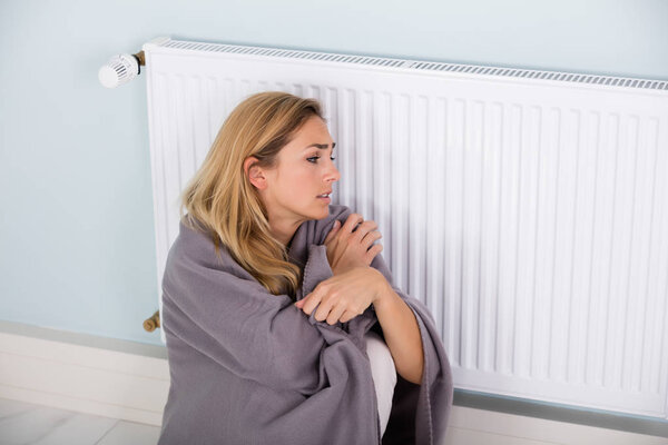 Woman Sitting Near Thermostat