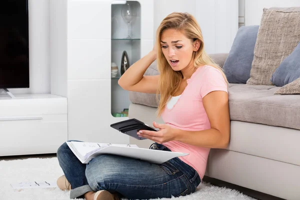 Mujer mirando calculadora — Foto de Stock