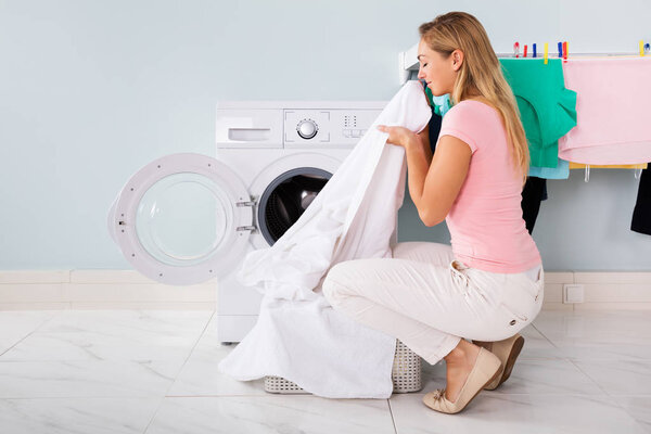 Woman Smelling Cleaned Clothes