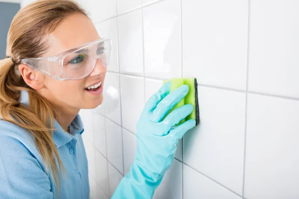 Woman Cleaning Wall