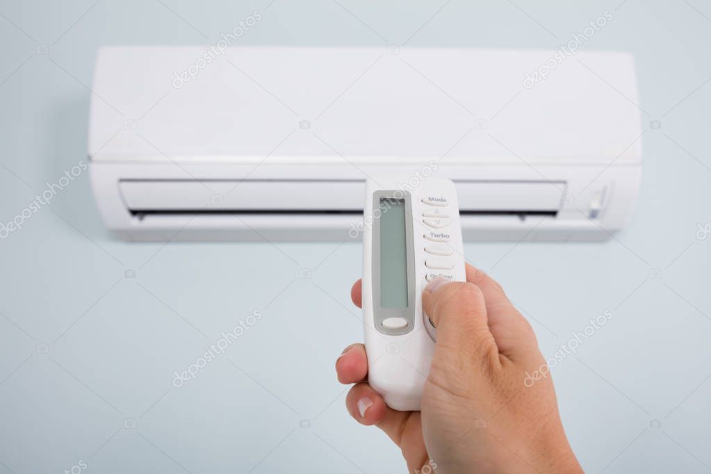Person Operating Air Conditioner 