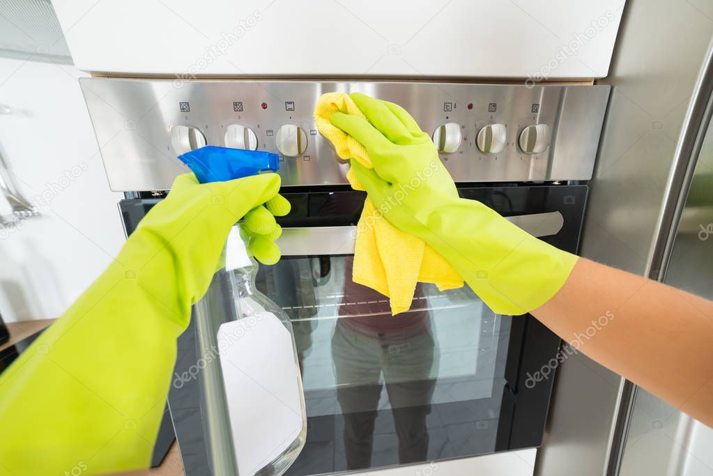 Woman Cleaning Oven