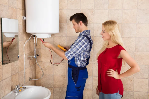 Worker Repairing Electric Boiler