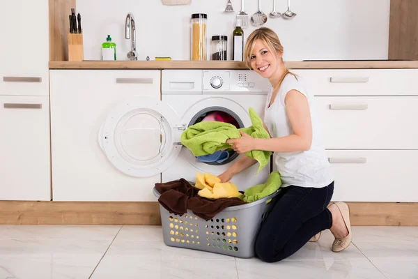 Kvinnan lastning kläder — Stockfoto