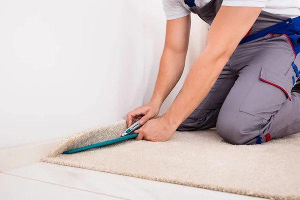 Řemeslník řezání koberec — Stock fotografie