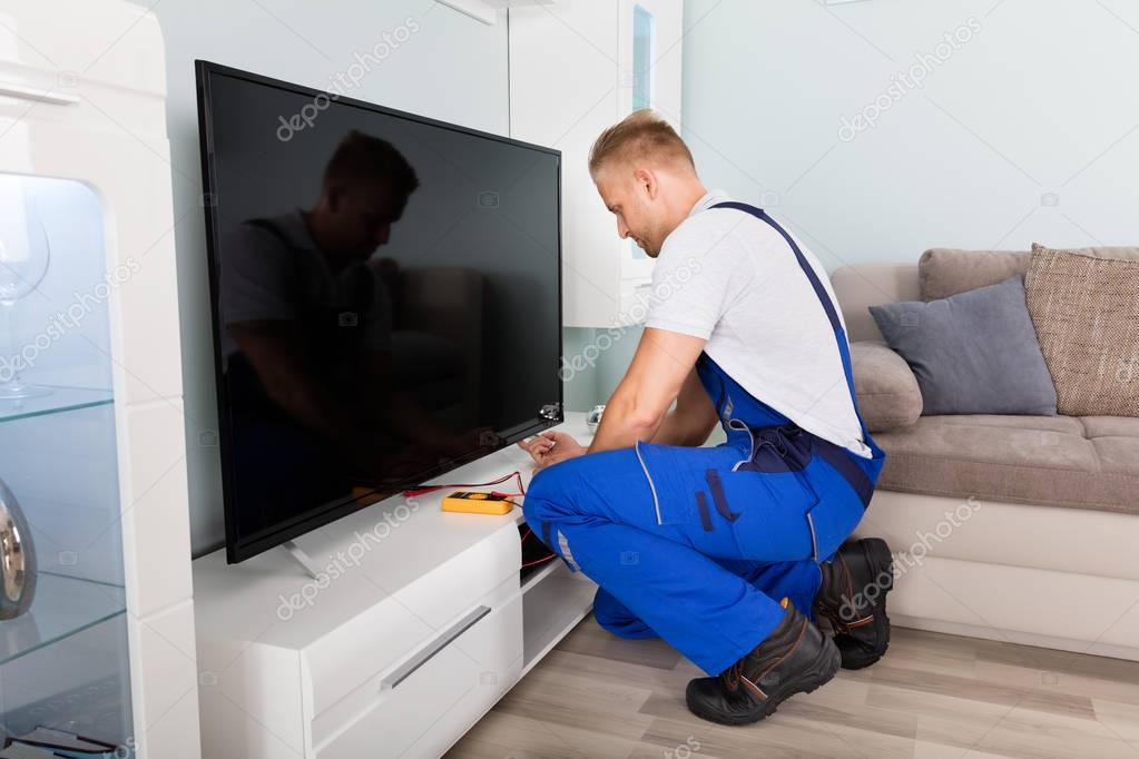Electrician Fixing Television